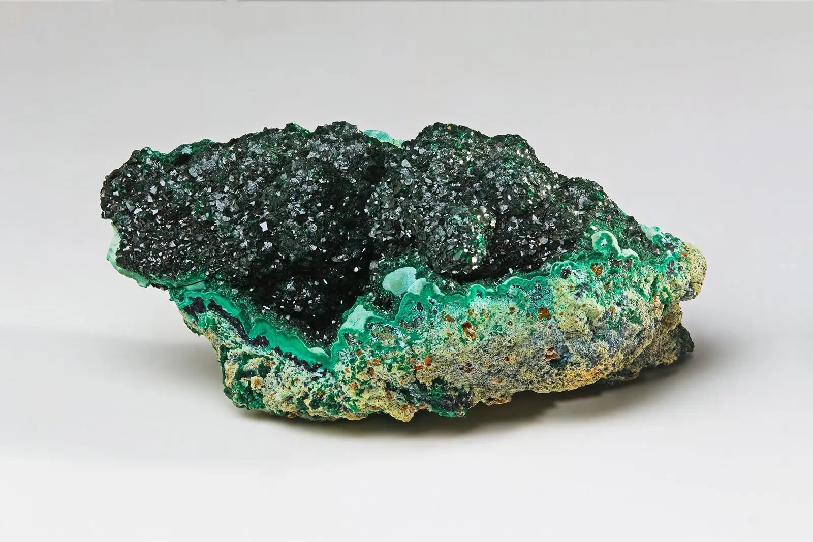 Banded green malachite, a copper ore mineral, with dark crystalline layers