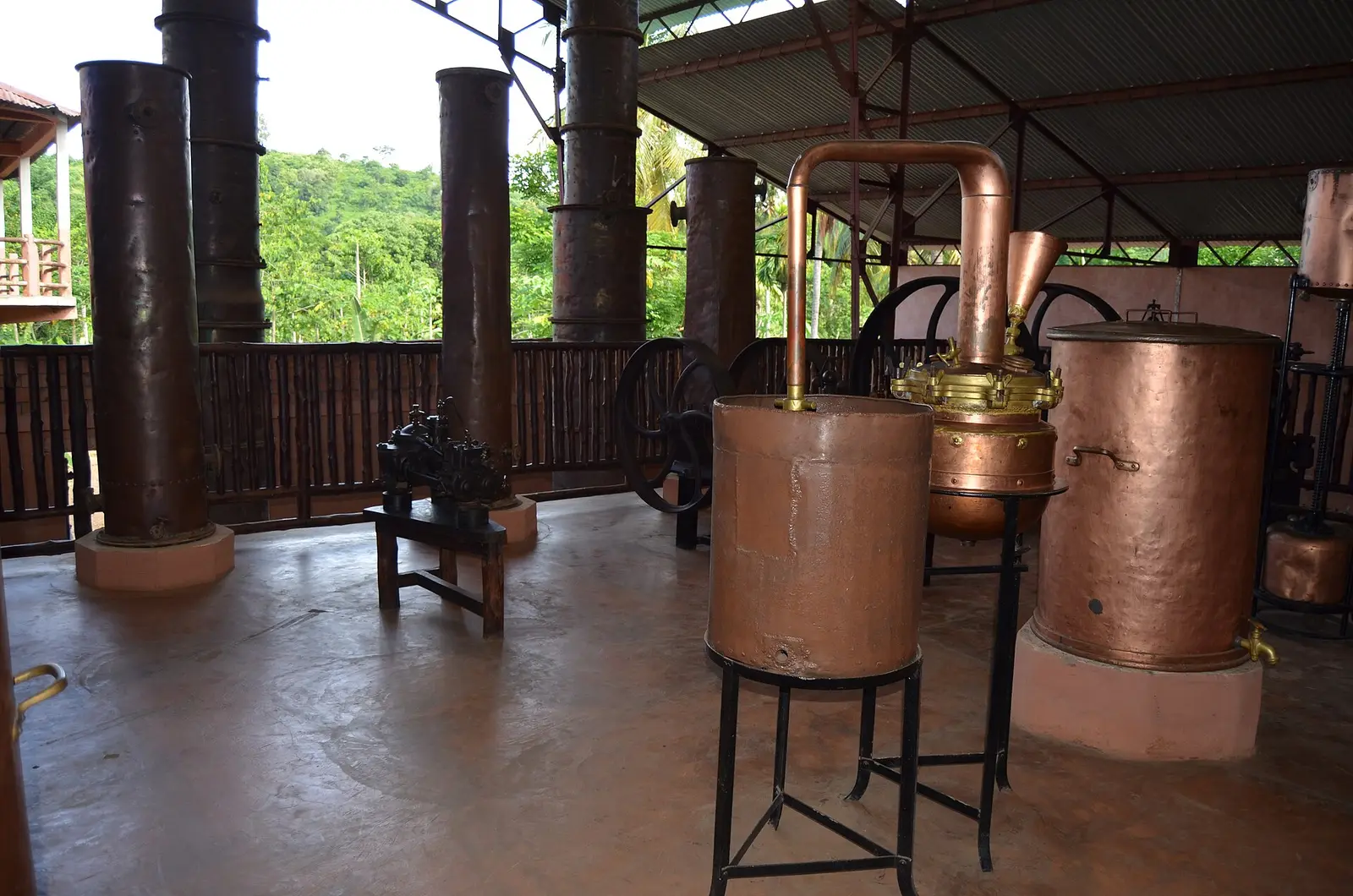Copper stills under an open shed at an essential-oil distillery